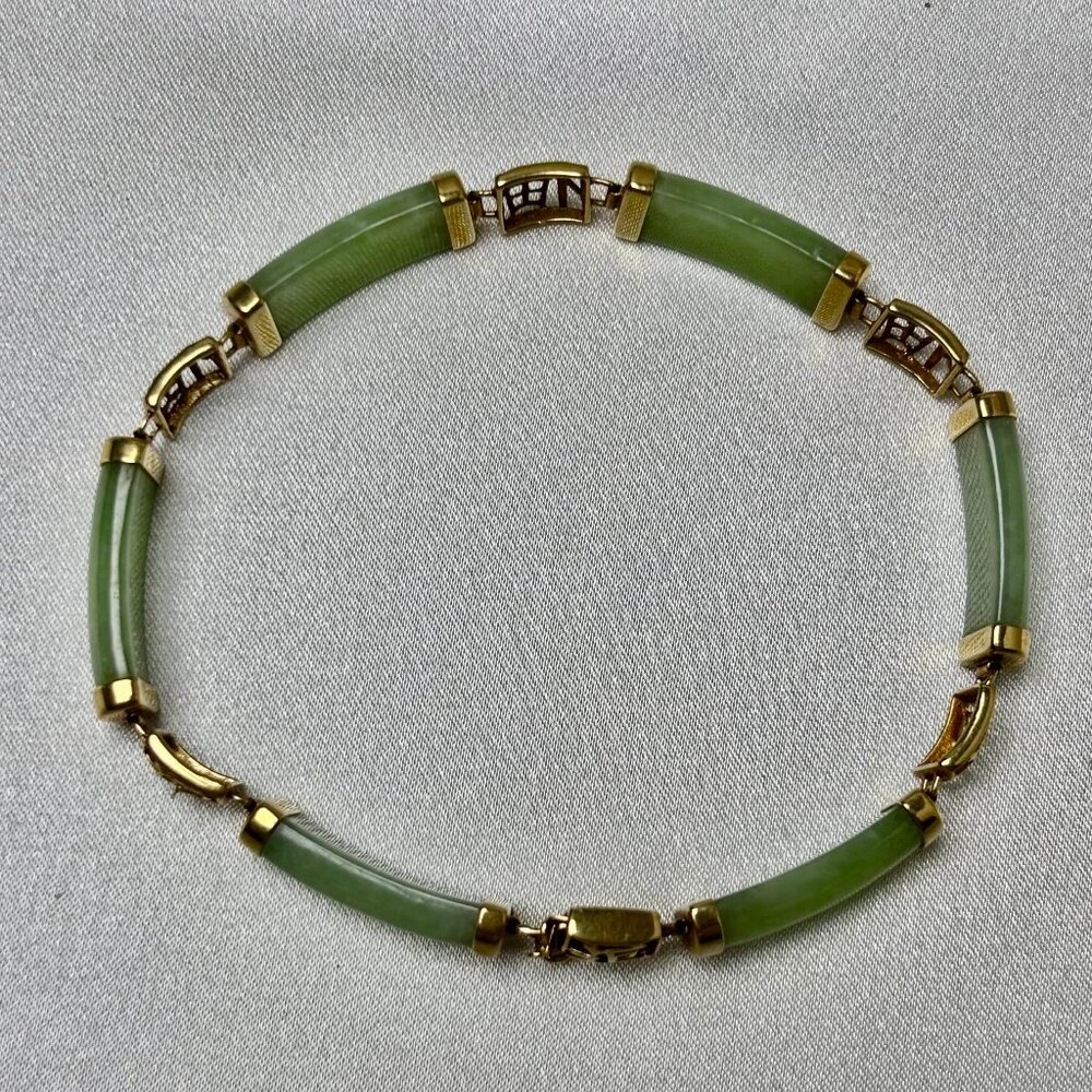 Green Jade lady's and 14k yellow gold pre-owned bracelet.